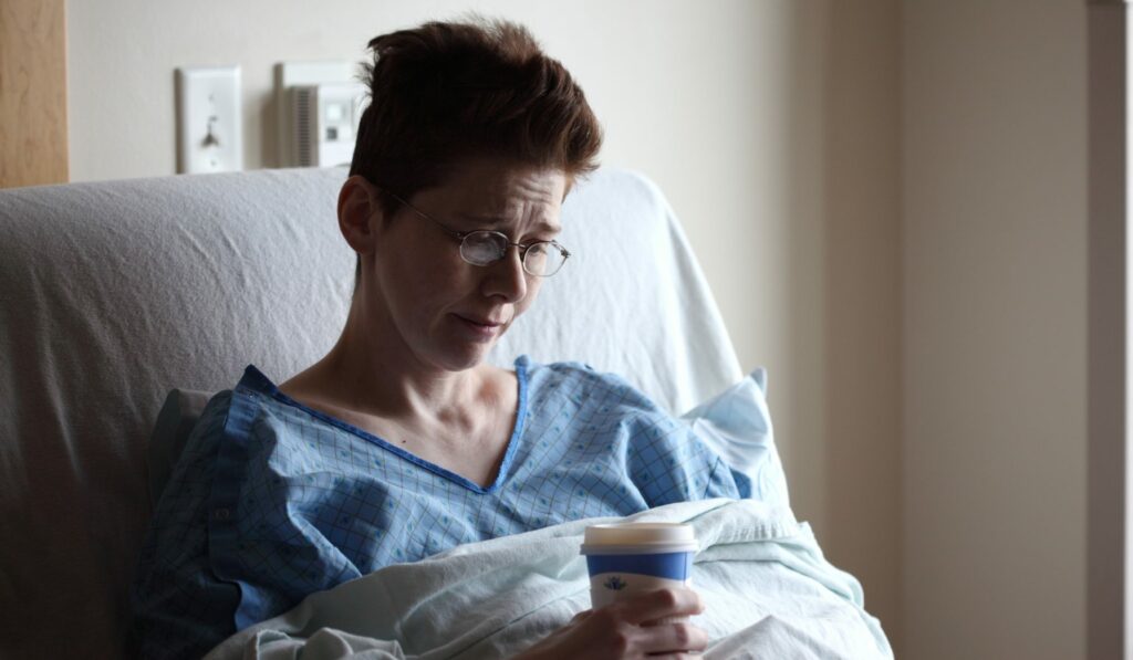 My wife about 18 hours after her right hemicolectomy surgery, drinking broth.